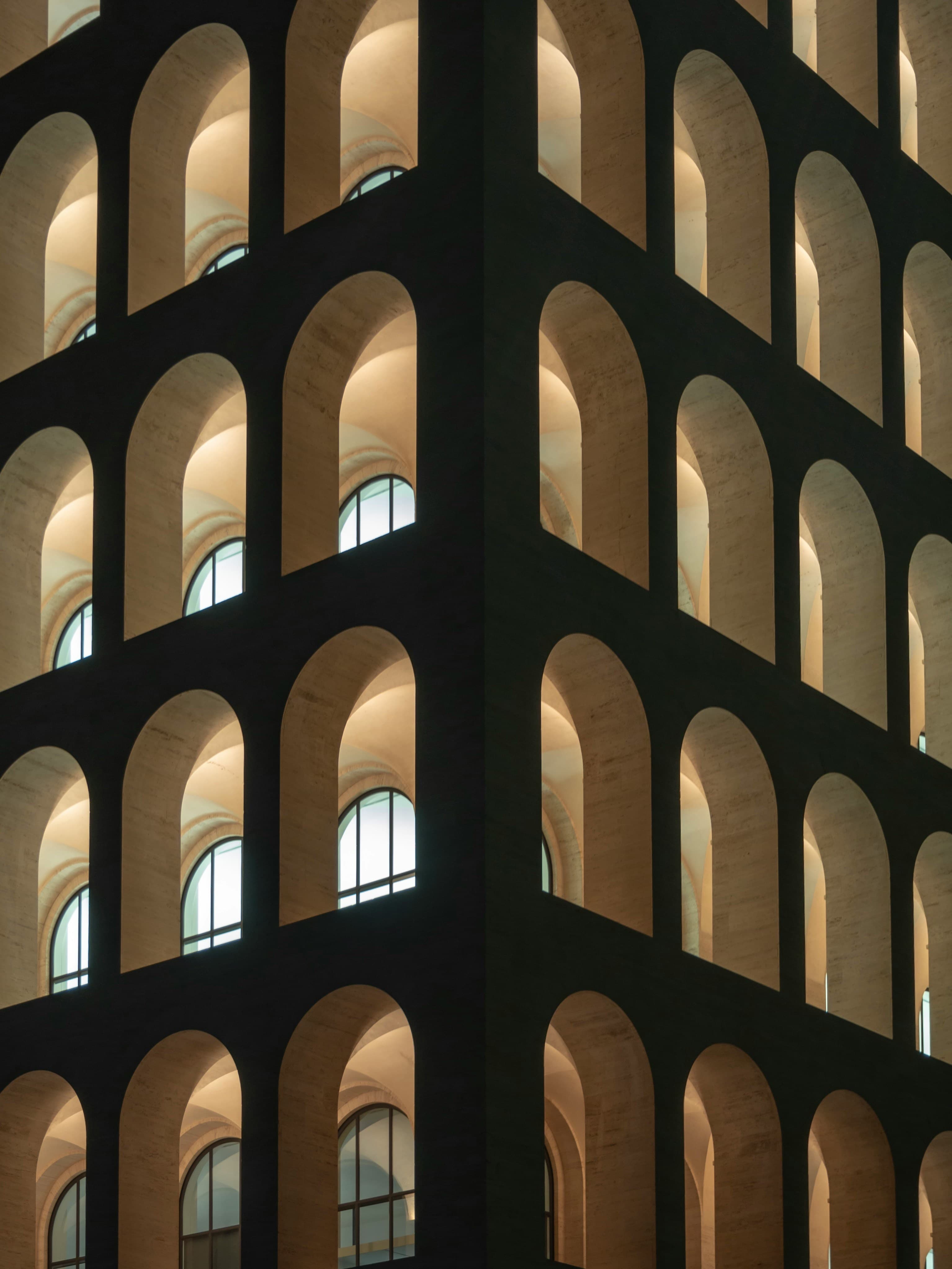 Rows of identical arches on a building facade — distinct things reduced to sameness