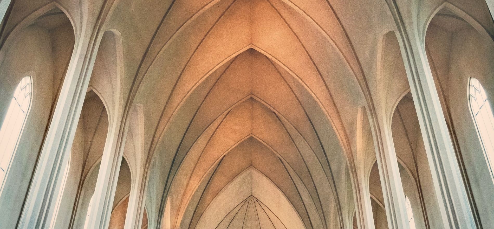 Repeating vaulted bays converging toward light